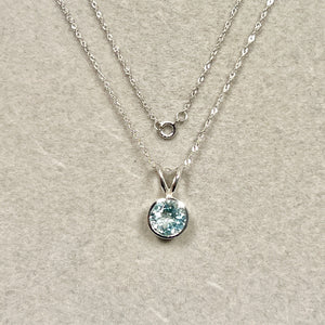 Shaped around clarity, 1.50–2.10 CTS aquamarine solitaire for women set in 14K white gold with smooth round bezel