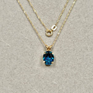 Dark Blue London Blue Topaz Pendant 2.95 Cts set in 18K Yellow Gold for women, oval stone with refined scroll profile