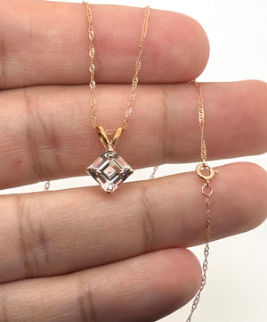 Side profile of four prong pendant setting with polished 14K rose gold craftsmanship detail 