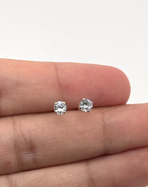 Sterling silver cubic zircon stud earrings shown for size reference 