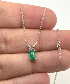 Side profile of 14K white gold emerald pendant highlighting polished finish and craftsmanship 