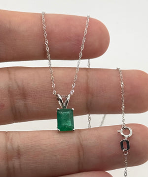 Natural emerald solitaire pendant styled for anniversary dinner and luxury gift inspiration 
