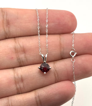 Elegant Garnet pendant worn for an anniversary celebration with timeless styling.