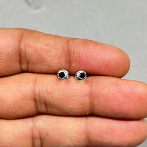 Pair of AAA round black diamond stud earrings set in polished 18K white gold, featuring two 2.5–3.0 mm diamonds in classic four prong settings with secure push back closures for womens fine jewelry wear. 