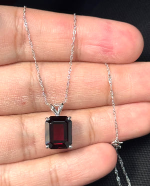 emerald cut garnet solitaire pendant in platinum