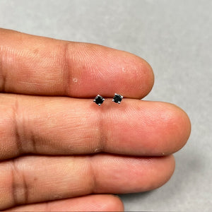 AA round black diamond stud earrings in 18K white gold featuring 2.50–3.00 mm stones in a four prong setting with push backs, minimal fine jewelry design for women, polished finish and classic everyday elegance. 