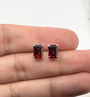 AAA 8x6mm Garnet stud earrings in polished 14K White Gold with four-prong settings