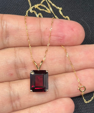 Large emerald cut garnet solitaire pendant in 14K yellow gold
