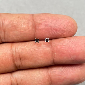 AA quality princess cut black diamond stud earrings set in solid 18K white gold with four prong settings and secure push backs. Minimal square black diamond studs measuring 2.00–2.50 mm, designed for women who prefer refined fine jewelry. 