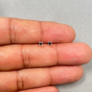 AA quality princess cut black diamond stud earrings set in solid platinum, featuring two 2.00–2.50 mm square black diamonds in a four prong setting with secure push back closures for everyday fine jewelry wear. 