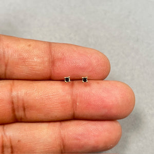 14K yellow gold black diamond stud earrings featuring two AAA quality princess cut black diamonds in a secure four prong setting, sized 2.00–2.50 mm with push back closure, offering a clean square silhouette and bold contrast for everyday wear. 