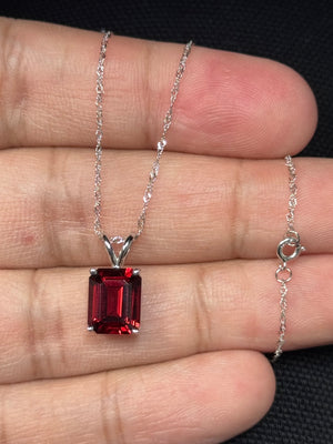 emerald cut garnet solitaire pendant in 14k white gold