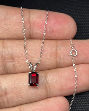 emerald cut garnet solitaire pendant in 14k white gold