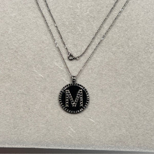 0.85 carat black diamond M initial pendant necklace in solid 14K white gold, featuring 65 round AA quality diamonds prong set to form the letter M. Paired with an 18 inch white gold Singapore chain and secured with a spring ring clasp, this personalized monogram necklace offers bold sparkle and modern elegance for women. 