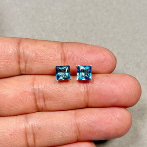 Swiss blue topaz stud earrings in 14K yellow gold princess cut design