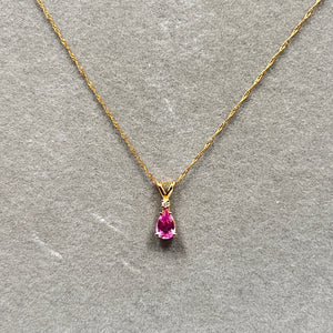 0.58 Ct natural pink sapphire and diamond pendant necklace crafted in 14K yellow gold, featuring a 6x4mm heated AA quality pink sapphire accented with a 0.02 Ct round diamond in prong setting. Suspended from an 18 inch Singapore chain with spring ring clasp, elegant fine gold gemstone jewelry for women with soft romantic glow and delicate sparkle. 