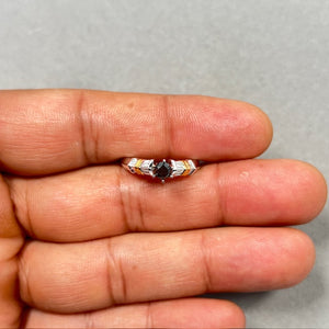 18K two tone gold ring in size 7 featuring a 0.45 Ct round black diamond in prong setting, surrounded by 16 baguette cut white diamonds totaling 0.30 Ct in channel setting. Crafted in white and yellow gold with rhodium finish, 2.0–2.5 mm width, bold black and white contrast design with refined elegance. 