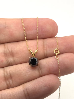 Side view showing four prong setting, polished 14K yellow gold and secure pendant craftsmanship 