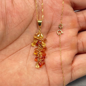 Multi Sapphire Briolette pendant in solid 18K yellow gold featuring natural AA-quality orange sapphires in light to dark hues. Elegant 6–8 carat gemstone drop suspended from an 18-inch Singapore chain with a secure spring ring clasp. Luxury colorful sapphire necklace for women with refined brilliance and handcrafted finish. 