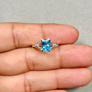 Swiss blue topaz ring in 14K white gold radiant cut gemstone with diamond accents prong setting