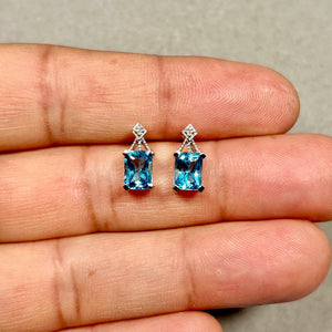 Swiss blue topaz earrings in 14K white gold with diamond accents, classic stud design for elegant everyday jewelry