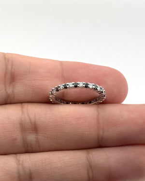 Black and white diamond eternity ring presented in an elegant jewelry box as an anniversary gift for her 