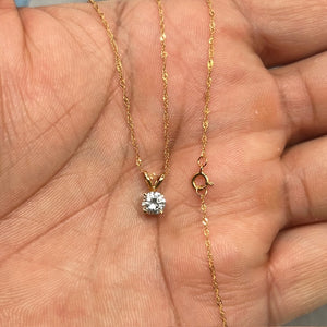 Natural white sapphire solitaire pendant crafted in 14K yellow gold, featuring a 5mm round AA quality gemstone in a classic prong setting. The transparent heated sapphire sparkles brilliantly and hangs from an 18-inch Singapore chain with a secure spring ring clasp, offering timeless elegance for everyday wear or special occasions. 