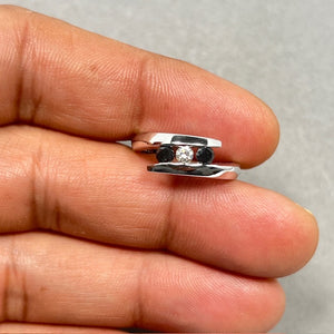 3/4 carat black and white diamond three stone ring in 14K white gold, featuring a 0.20 Ct center white diamond and two channel set black diamonds totaling 0.56 Ct, rhodium plated finish, size 6 fine jewelry ring with symbolic past present future design and elegant polished band. 