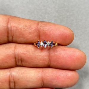 14K yellow gold tanzanite and diamond ring featuring three natural AA violet tanzanites and two round white diamonds in a classic prong setting. Lightweight 1.542 gram gold band, size 5.5, designed for women who love elegant fine jewelry with a subtle sparkle for daily wear or special occasions. 