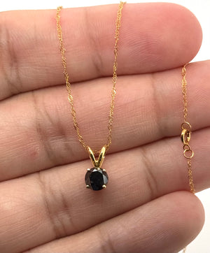 Side view of four-prong pendant setting in 14K yellow gold showing secure stone craftsmanship 