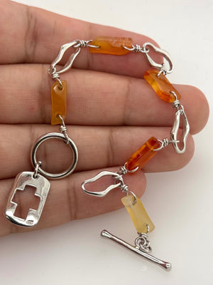 Silver bracelet shown for scale with toggle clasp and proportions visible for size reference 