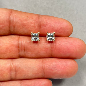 Pair of 6mm cushion checkerboard aquamarine stud earrings crafted in solid 14K yellow gold, featuring AA quality heated natural aquamarines in an elegant scroll frame setting with secure push back closures, displaying a soft light blue ocean-inspired sparkle and refined handcrafted finish. 