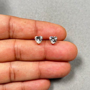 6 mm AA heart cut cubic zirconia stud earrings in 14K yellow gold with classic prong setting and secure push-back closures, featuring brilliant heart-shaped stones that reflect light beautifully. Elegant, minimalist gold studs designed for everyday wear, romantic styling, and refined occasions. 