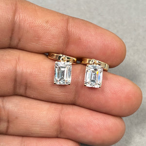8x6 mm emerald cut cubic zirconia stud earrings in solid 14K white gold with rhodium finish, featuring AA quality clear stones in a secure four-prong setting. Designed with elegant dangle lever backs for comfortable wear and subtle movement. These rectangular CZ earrings offer a refined, minimalist look, perfect for formal events, bridal styling, or everyday sophistication for women. 