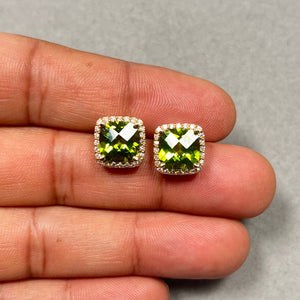 Luxurious 14K yellow gold stud earrings featuring vibrant 8mm cushion checkerboard AAA peridot gemstones totaling 4.30 carats, beautifully framed by sparkling natural round diamonds weighing 0.36 carats. The prong-set design highlights the vivid green peridot brilliance while secure push backs ensure comfortable wear. Elegant diamond halo peridot earrings perfect for refined women’s jewellery collections. 