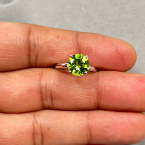 Handcrafted 2.88 Ct round Peridot solitaire ring in solid 14K white gold with rhodium finish, featuring a vibrant 9mm AAA natural green peridot in a classic four-prong setting. Elegant August birthstone ring for women, size 6.5, designed with timeless brilliance and refined gemstone jewellery style. 
