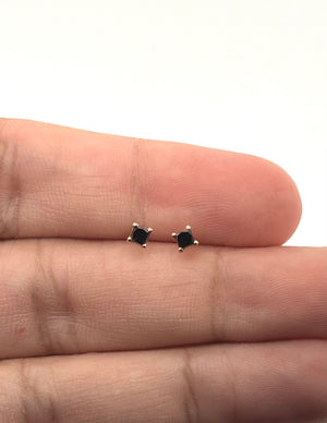 Side view of four-prong black diamond stud setting with 18K yellow gold construction 