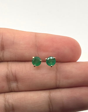 Side view of prong-set emerald earrings showing polished 18K yellow gold craftsmanship