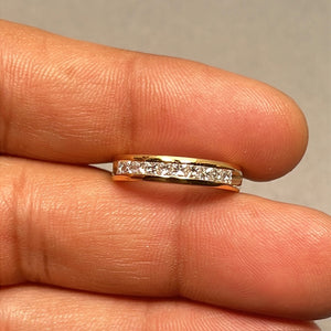 Princess cut diamond wedding band in 18K yellow gold featuring 0.45 to 0.50 carat total weight natural diamonds in a sleek channel setting. This elegant women’s ring showcases SI1 to SI2 clarity stones with I to J color, offering a refined balance of sparkle and durability. A slim 2 mm gold band designed for stacking or wearing solo with timeless sophistication. 