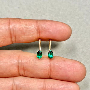 Emerald earrings styled at celebration event for elegant gift intent 