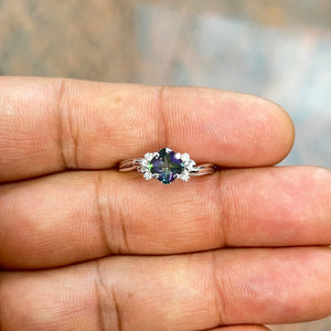 AAA Mystic Fire Topaz and Diamond ring in 14K white gold, featuring a 6mm cushion checkerboard cut topaz with vibrant rainbow color play. Accented by four round brilliant diamonds totaling 0.05 carat, set in a sleek polished band with rhodium finish. Elegant women’s gemstone ring size 7, designed for modern luxury, everyday wear, and special occasions. 