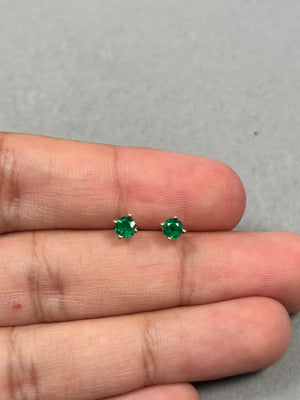Elegant 0.42–0.55 Ct natural emerald stud earrings in 18K yellow gold. 4mm round AA green gemstones in a timeless scroll design for women