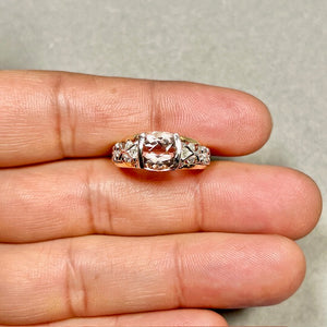 Flat lay of peach Morganite ring with luxury styling and elegant accessories 