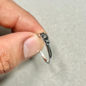 Black diamond jewelry collection featuring coordinating white gold rings with timeless styling 