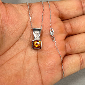 Elegant 1.59 Ct cushion checkerboard Citrine pendant with 0.10 Ct round Diamonds set in 14K White Gold. Suspended on an 18-inch Singapore chain, this radiant pendant showcases warm golden hues, exquisite craftsmanship, and timeless elegance. Perfect for women seeking a versatile piece that complements both casual and formal attire. 