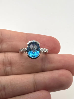 close up of blue topaz gemstone with bezel diamond accents