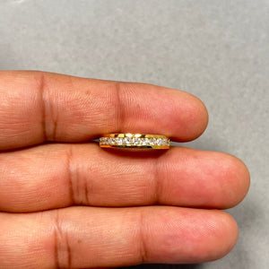 Elegant 18K yellow gold diamond wedding band featuring twelve natural round-cut diamonds in a secure channel setting. With a total weight of approximately 0.55–0.60 carats, these SI2–I1 clarity diamonds in I–J color create a soft yet radiant sparkle. The polished gold band, measuring around 3.5–3.9 mm wide, offers a refined and timeless look, perfect for women seeking a classic and durable wedding ring.