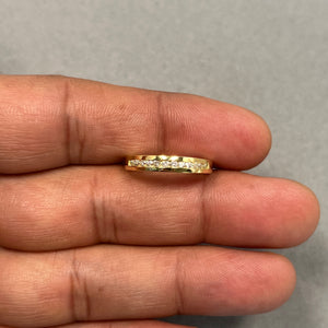 18K yellow gold women’s wedding band featuring twelve round channel-set diamonds totaling 0.20–0.25 carats. Designed with I–J colour and SI2–I1 clarity stones, this size 7 ring offers a smooth 2.85–3.75 mm profile for a comfortable fit. A refined diamond band ideal for stacking, anniversaries, or everyday wear with a subtle, elegant sparkle. 