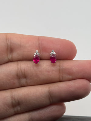 Oval ruby earrings in 18K white gold with diamond accents prong setting elegant ruby jewelry