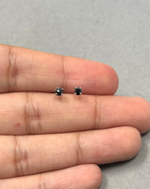 AA quality round rose cut black diamond stud earrings in 18K white gold, four prong setting with push backs, 2.50–3.00 mm stones, total weight 1/4 carat, classic minimalist diamond studs for everyday fine jewelry wear. 